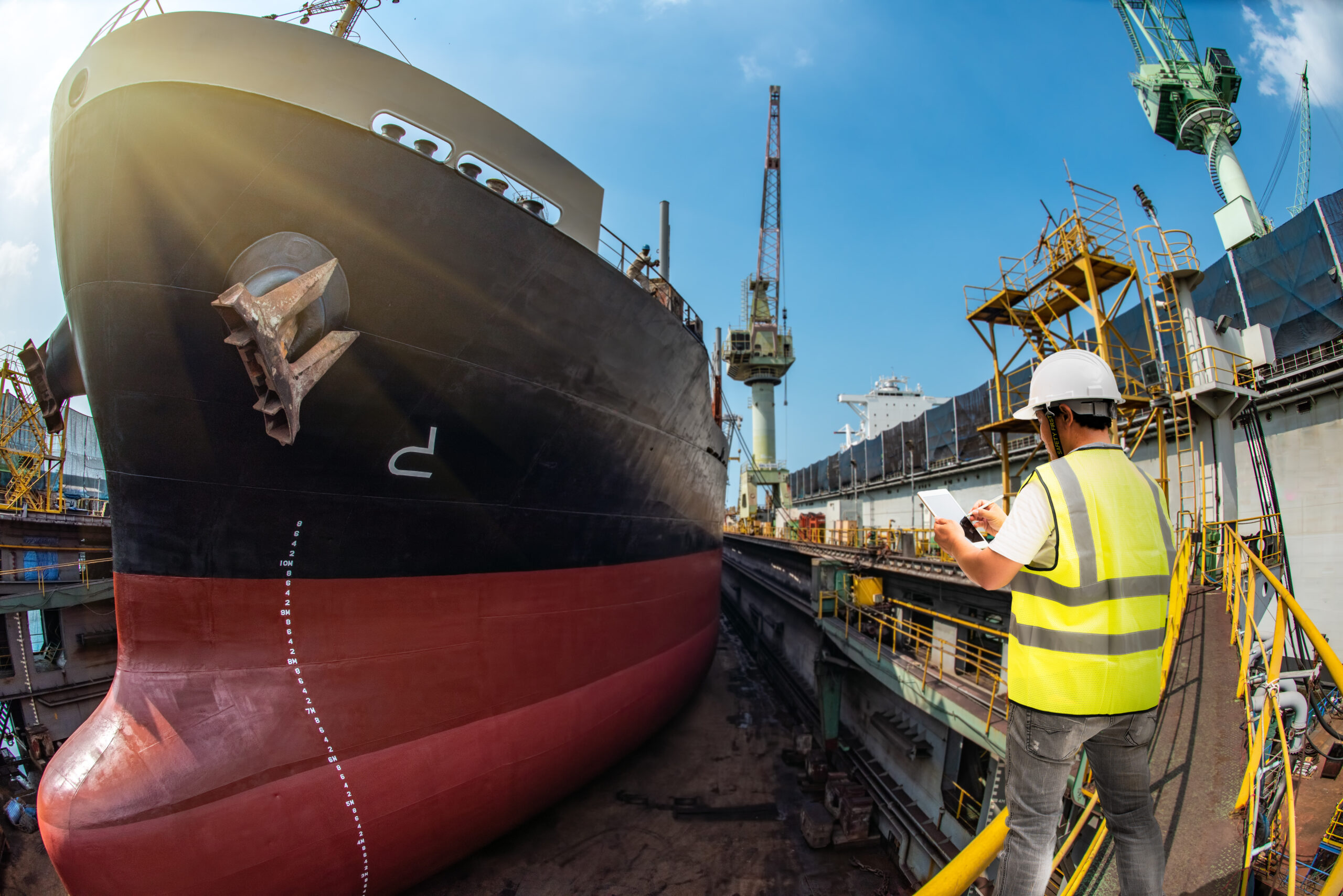Stevedore, port controller, Port Master, surveyor inspect the bulk head of commercial cargo ship in floating dry dock yard, recondition of overhaul repairing and repainting, working in dry dock yard